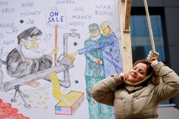 A woman plays the role of a person being hanged as Iranian community member takes part in a protest in solidarity with Iranian people, in Brussels, Belgium, February 20, 2023