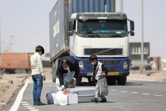 Afghan nationals stand at the Dowqarun border crossing between Iran and Afghanistan, Razavi Khorasan Province, Iran August 29, 2021.