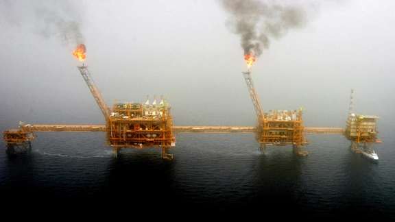 Gas flares from an oil production platform at the Soroush oil fields in the Persian Gulf, July 25, 2005.
