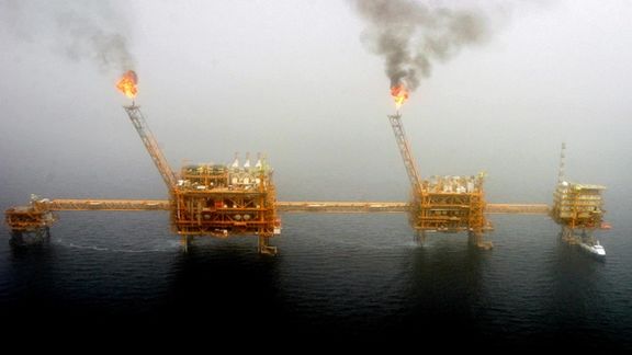 Gas flares from an oil production platform at the Soroush oil fields in the Persian Gulf, July 25, 2005.
