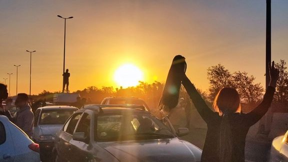 A woman has removed her headscarf during a protest, November 3, 2022