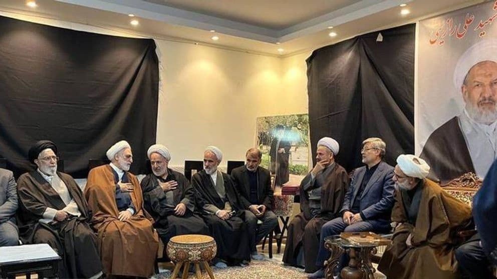 Iran's Judiciary Chief (second from left) visits the house of Ali Razini, one of the two judges who were shot dead in Tehran on January 18, 2025