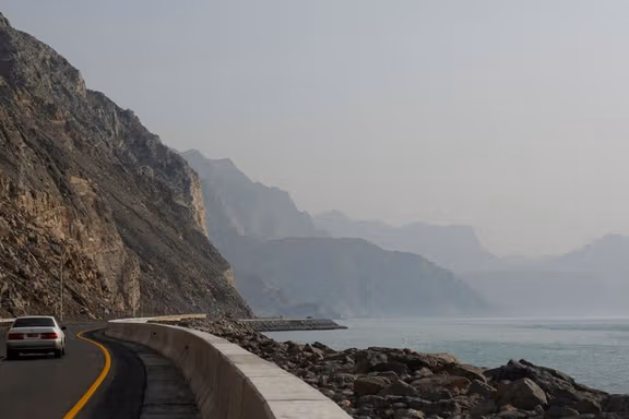 A car rides along the coast of Musandam overlooking the Strait of Hormuz amid the US-Israeli conflict with Iran, Oman, March 2, 2026.