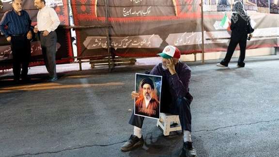 A man holds a portrait of Iran’s Supreme Leader Mojtaba Khamenei during a gathering in Tehran on June 8, 2026.