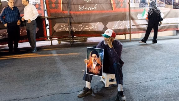 A man holds a portrait of Iran’s Supreme Leader Mojtaba Khamenei during a gathering in Tehran on June 8, 2026.