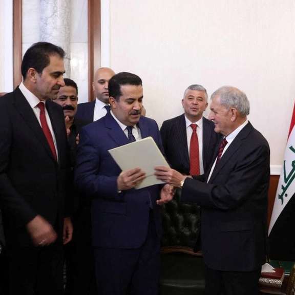 Iraq's new president Abdul Latif Rashid (R) appointing Shia al-Sudani premier on Oct. 13, 2022