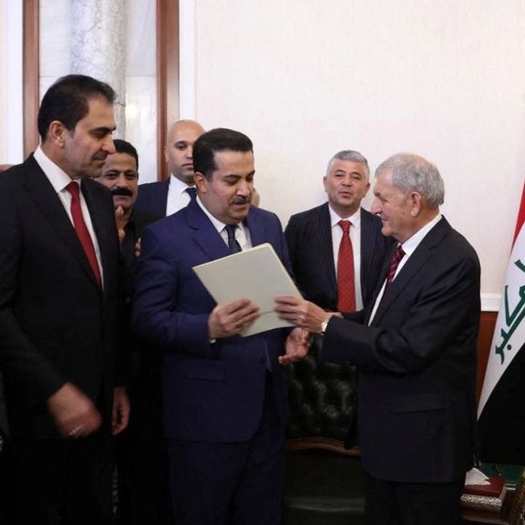 Iraq's new president Abdul Latif Rashid (R) appointing Shia al-Sudani premier on Oct. 13, 2022