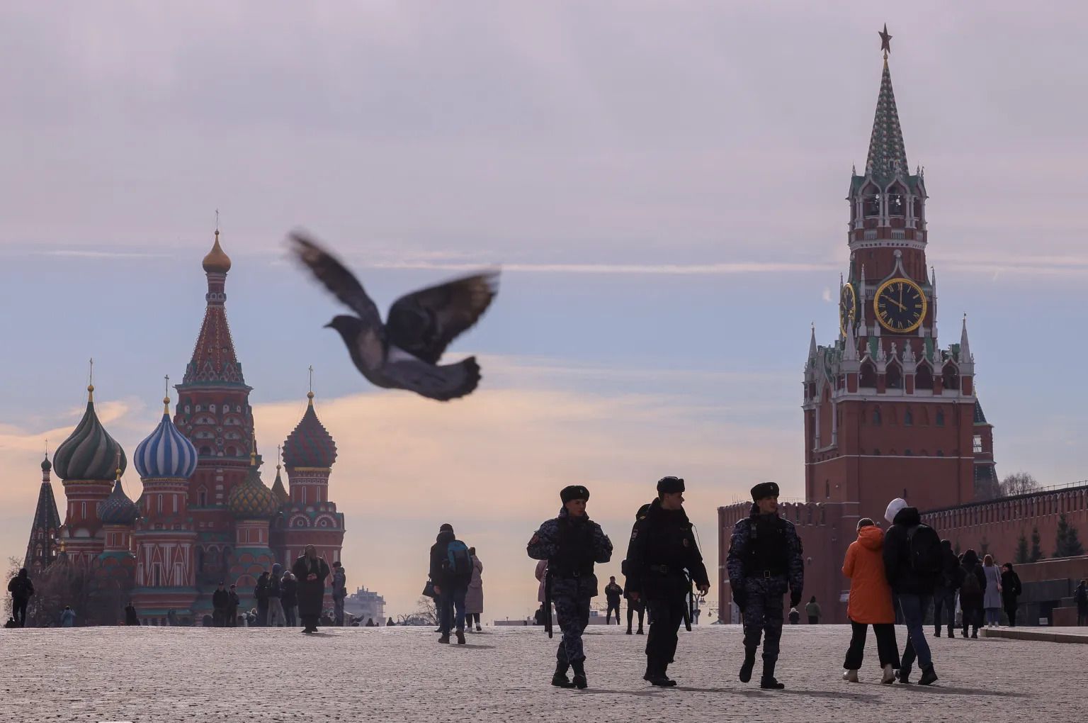  Russian law enforcement officers walk near St. Basil's Cathedral and the Kremlin's Spasskaya Tower on March 20, 2023.