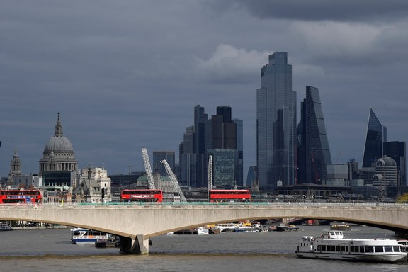 London buses cross Waterloo Bridge as St Paul's Cathedral is seen together with skyscrapers in the City of London financial district, Britain, October 16, 2020.