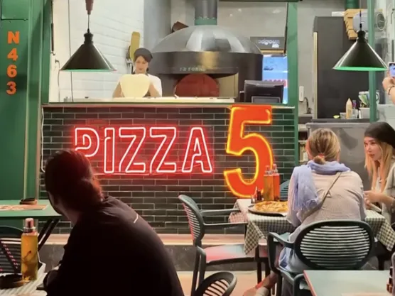 Customers sit outside Pizza 5 in Tehran in this undated file photo
