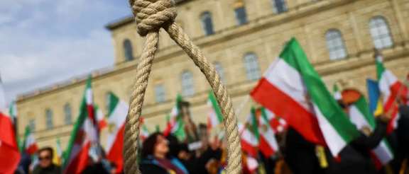 A noose is seen as people hold Iranian flags during a protest on the day of the Munich Security Conference, in Munich, Germany February 17, 2023.