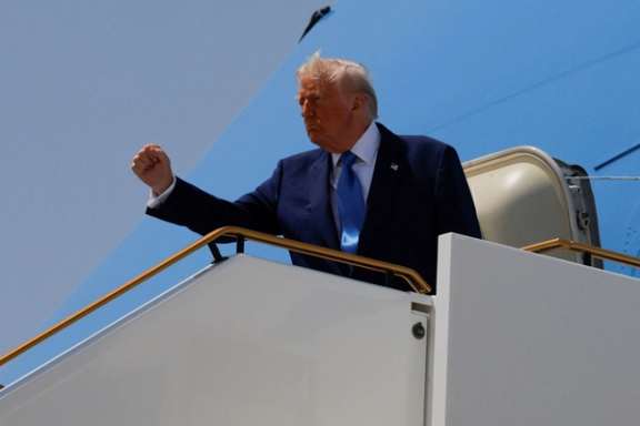 US President Donald Trump gestures, while he boards Air Force One, in Abu Dhabi, United Arab Emirates, May 16, 2025.