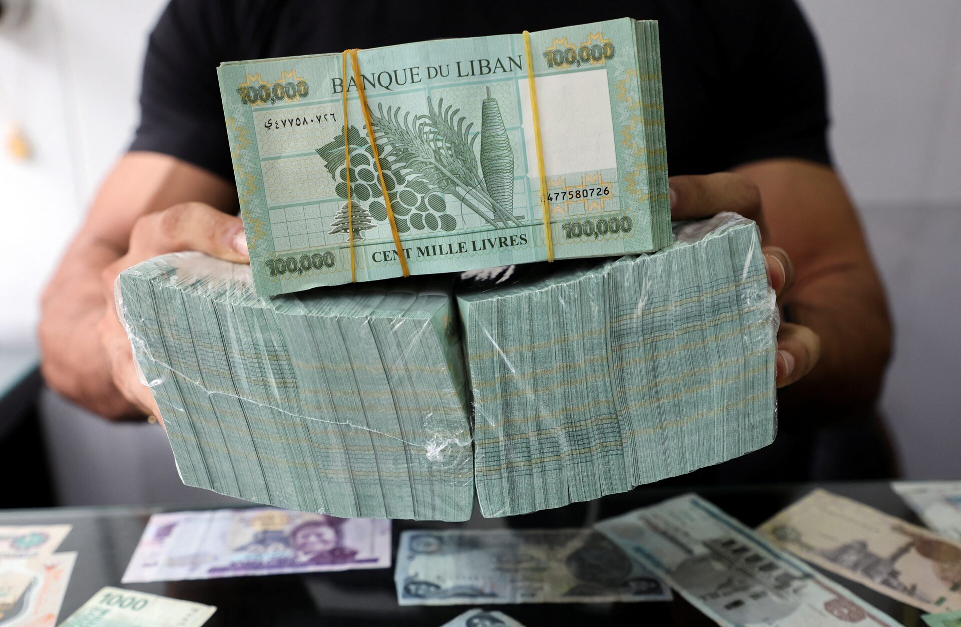 A money exchange vendor displays Lebanese pound banknotes at his shop in Beirut, Lebanon September 19, 2022