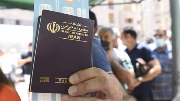 A man holding an Iranian passport