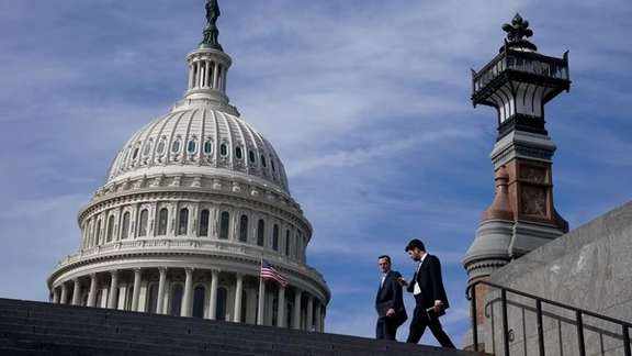 People walk past the US Capitol building in Washington, November 15, 2023.