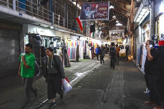 People walk in Tehran's Grand Bazaar, April 2026