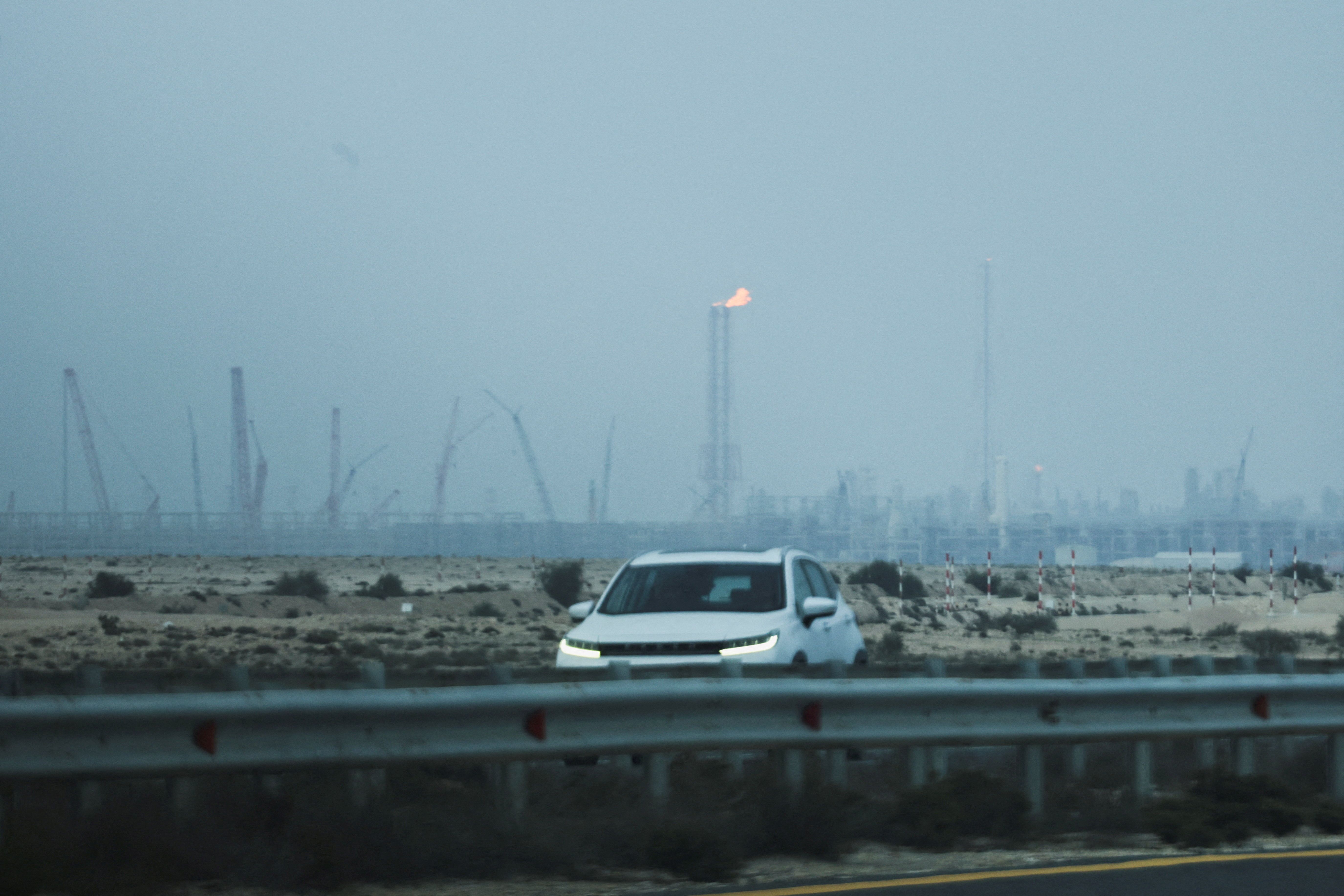 A car passes near QatarEnergy's liquefied natural gas (LNG) production facilities, amid the US-Israeli conflict with Iran, in Ras Laffan Industrial City on March 2, 2026.