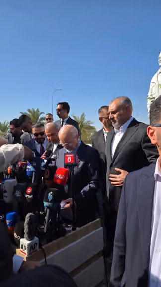 Iranian Parliament Speaker Mohammad Bagher Ghalibaf speaks to reporters in front of statues of Qassem Soleimani and Abu Mahdi al-Muhandis in Baghdad, Iraq, on August 19, 2026.