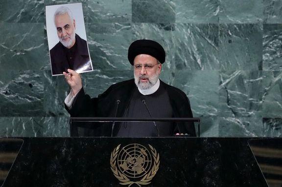 Iran's President Ebrahim Raisi holds up a picture of Quds Force Commander General Qassem Soleimani as he addresses the 77th Session of the United Nations General Assembly at UN Headquarters in New York City, US, September 21, 2022