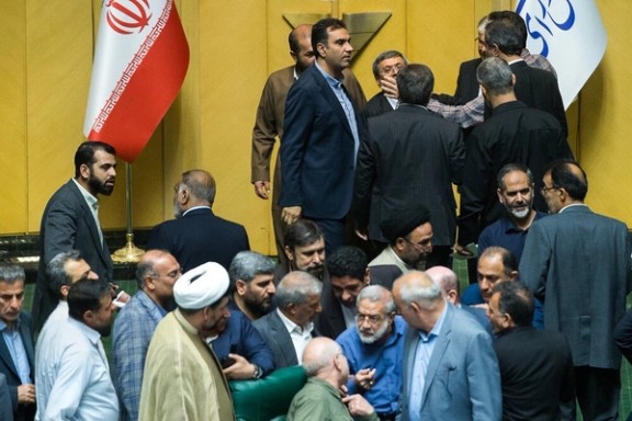 Iranian lawmakers debate in multiple huddles during a tense open session in parliament, Tehran, Iran, October 14, 2025