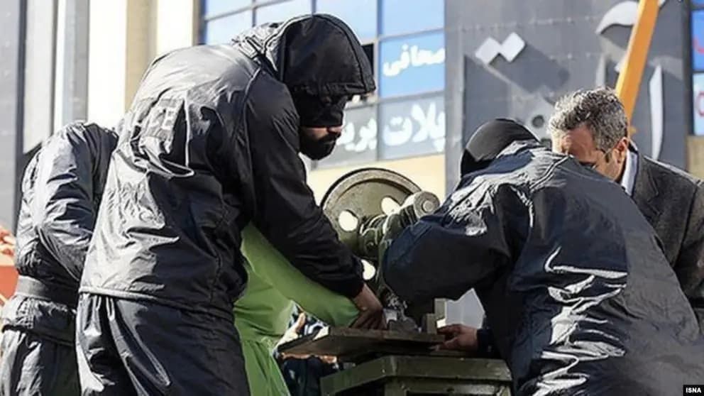 File photo of a prisoner being amputated by a guillotine-like device in Iran