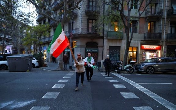 Said and Guiti, who have lived in Spain for over 40 years as refugees from Iran, carry flags to attend a demonstration in support of the national protests in Iran, in Barcelona, Spain January 13, 2026.