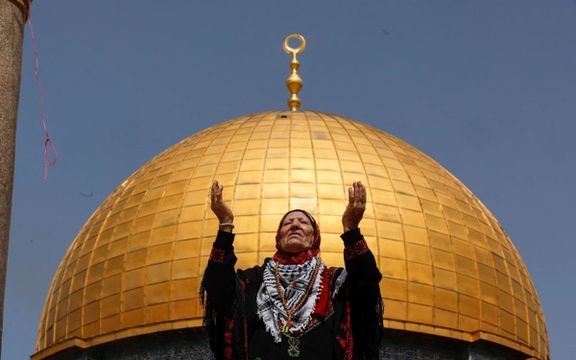 A woman prays as Palestinian Muslims attend Friday prayers of the Muslim holy month of Ramadan, on the compound known to Muslims as the Noble Sanctuary and to Jews as the Temple Mount, in Jerusalem's Old City, April 7, 2023.
