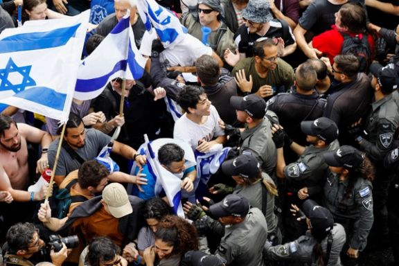 Demonstrators face members of the security forces during the "Day of Shutdown", as Israeli Prime Minister Benjamin Netanyahu's nationalist coalition government presses on with its judicial overhaul, in Tel Aviv, Israel March 23, 2023.