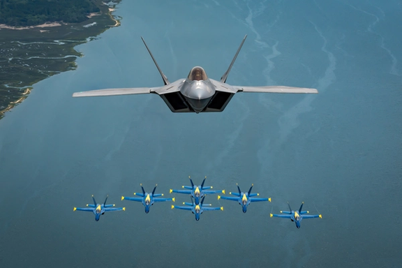 U.S. Air Force Major Paul 'Loco' Lopez, F-22 Demo Team commander/pilot, flies above the U.S. Navy Blue Angels' iconic diamond formation, in Beaufort, South Carolina, U.S. April 25, 2019.