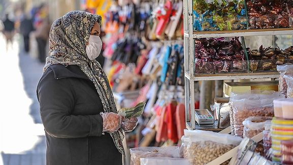 A woman looking at prices in Tehran's Bazaar