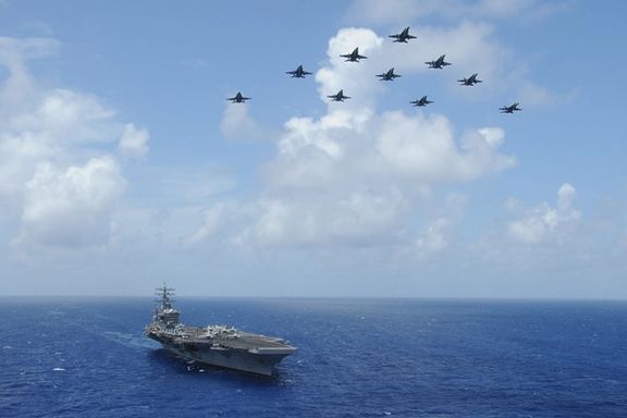 Handout photo dated July 2, 2013 shows F/A-18C Hornets assigned to the Wildcats of Strike Fighter Squadron (VFA) 131 fly over the aircraft carrier USS Dwight D. Eisenhower (CVN 69) during Carrier Air Wing (CVW) 7’s fly-off in the Atlantic Ocean.
