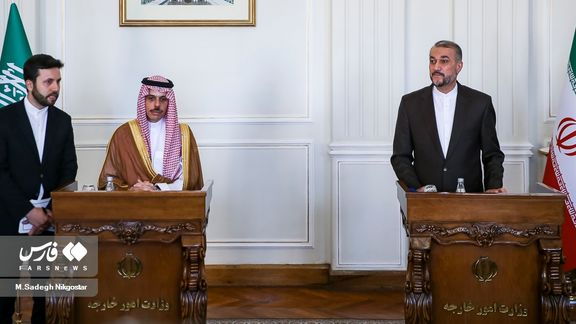 Iran's Foreign Minister Hossein Amir Abdollahian (R) points at while attending for speaking with media with his Saudi counterpart Faisal Bin Farhan, after an official meeting in Tehran's Foreign Ministry building, June 17, 2023.
