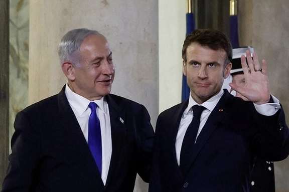 French President Emmanuel Macron welcomes Israeli Prime Minister Benjamin Netanyahu as he arrives for a dinner at the Elysee Palace, in Paris, France, February 2, 2023.