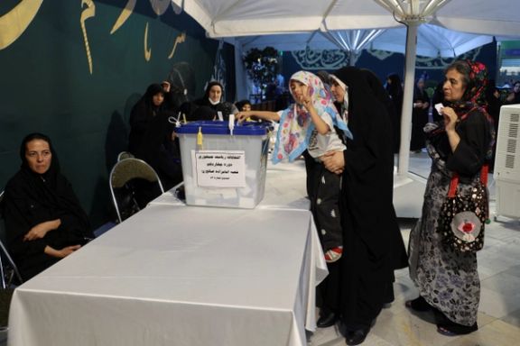 An Iranian child casts a vote at a polling station in a snap presidential election to choose a successor to Ebrahim Raisi following his death in a helicopter crash, in Tehran, Iran June 28, 2024.