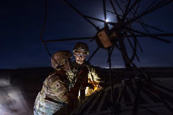 US Army paratroopers set up communications equipment at a remote site in the Middle East. (CENTCOM / X)