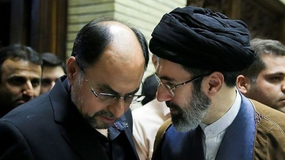 Mojataba Khamenei (R) speaking with his father's chief of staff. Undated