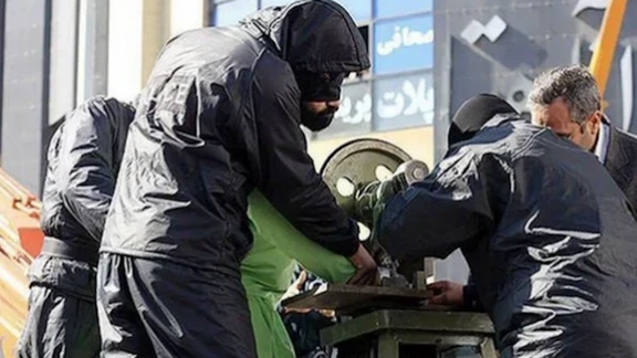 File photo of a prisoner being amputated by a guillotine-like device in Iran