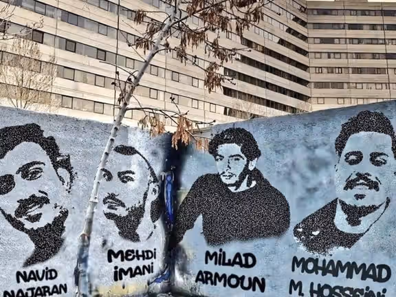 Graffiti depicting several defendants in the Ekbatan case on a wall in Tehran’s Ekbatan residential complex