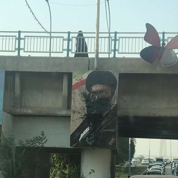 People threw paint on a Khamenei banner during anti-regime protests in October 2022.