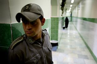 A prison guard stands along a corridor in Tehran's Evin prison, File Photo