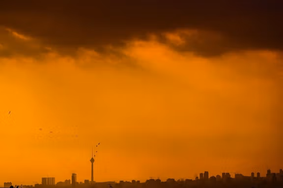 Tehran skyline at sunset, with the city's iconic Milad Tower rising in the distance, January 2026