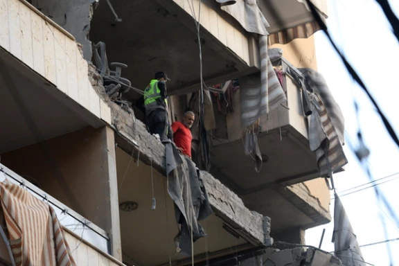People inspect a damaged building, after Israeli military said on Sunday that it struck a militant from the Lebanese Iran-aligned Hezbollah group, in Beirut's southern suburbs, Lebanon November 23, 2025.