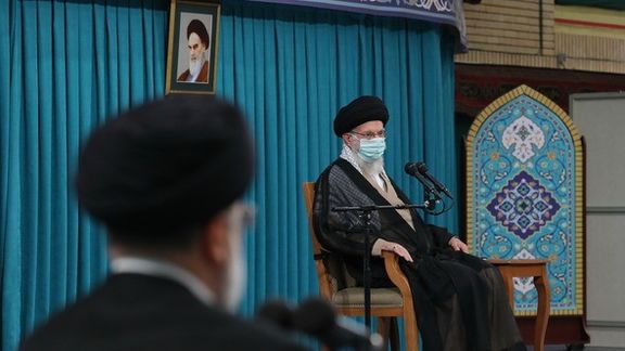 President Ebrahim Raisi listening to Supreme Leader Ali Khamenei on August 30, 2022