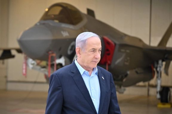 Israeli Prime Minister Benjamin Netanyahu standing next to an F-35 warplane.
