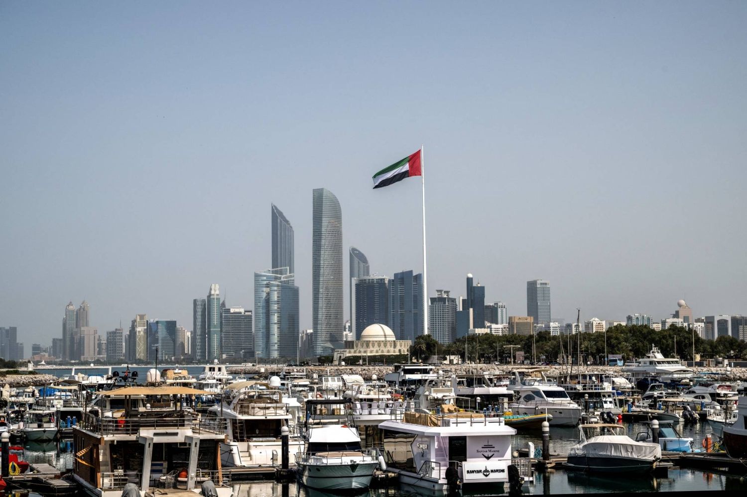 The United Arab Emirates flag flies over Abu Dhabi, a key regional hub for Iran-linked trade and finance. Photo: Ryan Lim/AFP/Getty Images