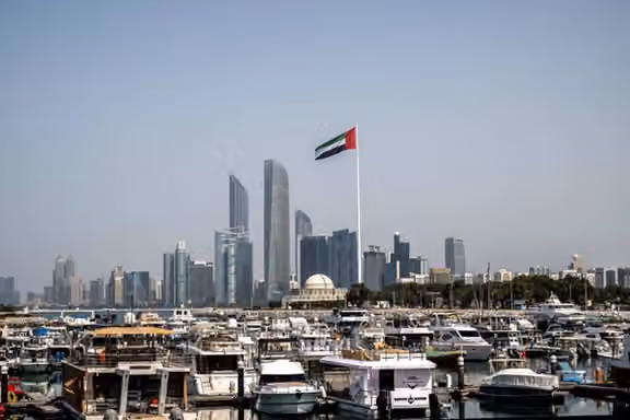 The United Arab Emirates flag flies over Abu Dhabi, a key regional hub for Iran-linked trade and finance. Photo: Ryan Lim/AFP/Getty Images