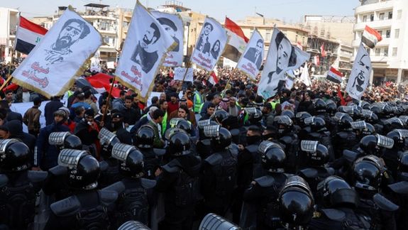 Police officers gather as Iraqi protesters demonstrate against the dinar's slide in value against the US dollar, near the central bank in Baghdad, Iraq, January 25, 2023.