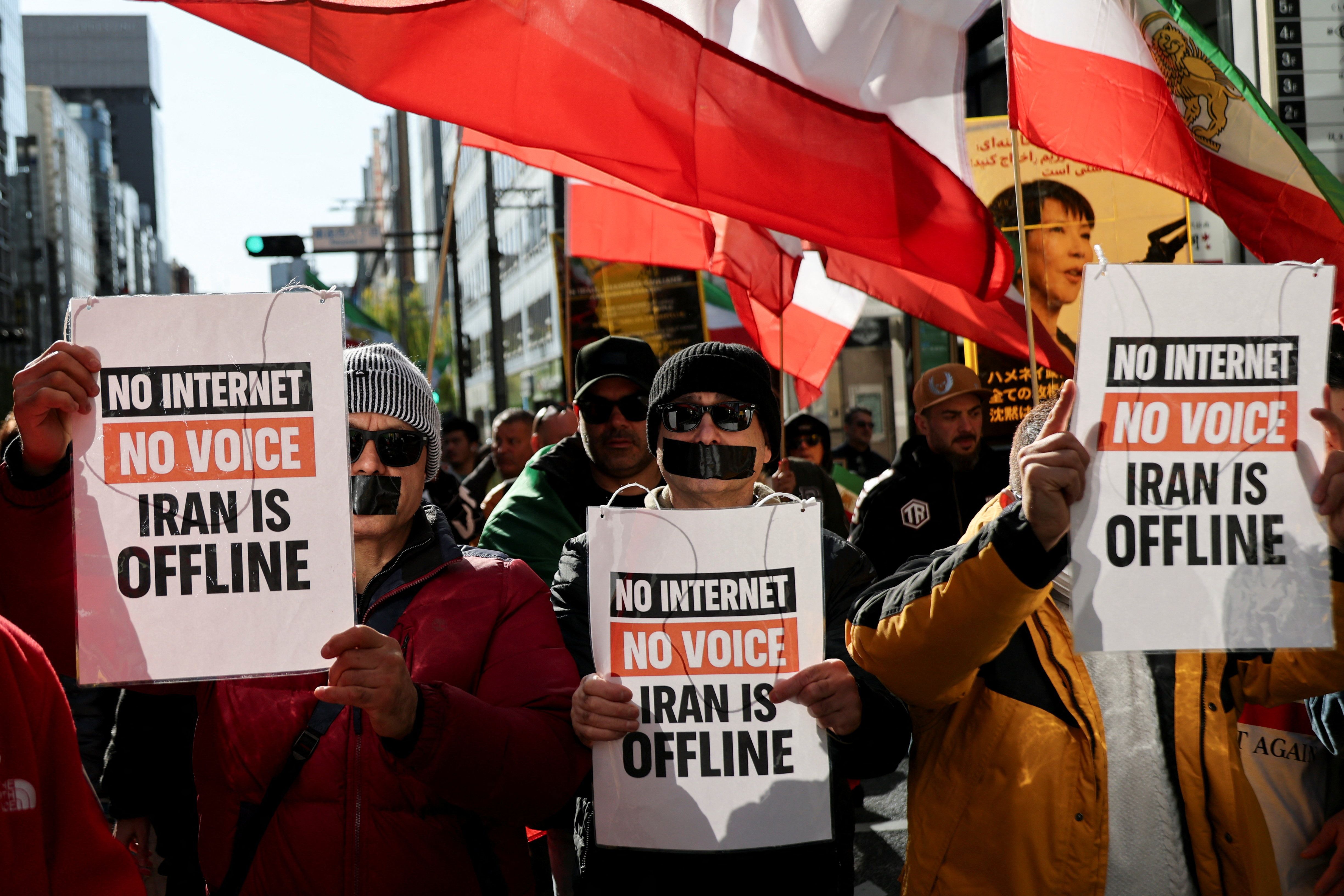 Iranians living in Japan, with taped mouths and carrying signs and flags, march in support of nationwide protests in Iran, in Tokyo, Japan, January 18, 2026.