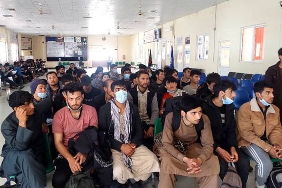 A group of Afghan men being processed to be returned to Afghanistan. Undated