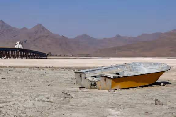 A wrecked boat beached on the dried floor of Lake Urmia in northwestern Iran, September 2025
